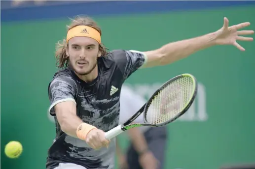  ?? — AFP ?? Stefanos Tsitsipas of Greece hits a return against Novak Djokovic of Serbia during their men’s singles quarterfin­al match at the Shanghai Masters tennis tournament in Shanghai on Friday.