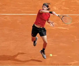  ??  ?? Greece's Stefanos Tsitsipas returns the ball to Russia's Aslan Karatsev during their match in Monaco on Tuesday