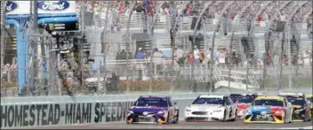  ?? AP PHOTO/LYNNE SLADKY ?? In this Nov. 18, 2018, file photo, Denny Hamlin (left) leads the pack at the start of the NASCAR Cup Series championsh­ip auto race at Homestead-Miami Speedway, in Homestead, Fla.