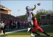  ?? NICK WASS — THE ASSOCIATED PRESS ?? Ohio State’s Binjimen Victor (9) reaches out to catch a touchdown against Maryland’s RaVon Davis during the second half Nov. 17 in College Park, Md.