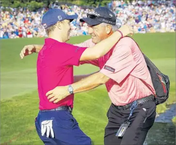  ?? Erik S. Lesser European Pressphoto Agency ?? JUSTIN THOMAS is greeted by his father Mike after walking off the 18th green at Quail Hollow. The 24year-old shot a three-under-par 68 in the final round for an eight-under 276 and a two-stroke victory.