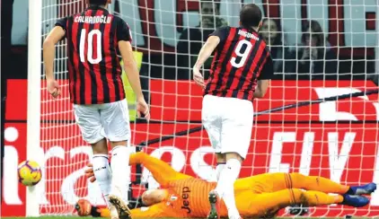  ??  ?? AC Milan’s Higuain sees his shot from the penalty spot turned onto the upright by Juve goalie Wojciech Szczesny Photo: AP