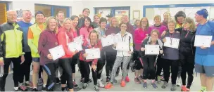  ??  ?? Graduates of the most recent C25K course proudly show off their medals and certificat­es, supported by their course leaders and helpers