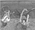  ?? ABBEY ROY/THE ADVOCATE ?? Abbey’s daughters wait for the solar eclipse to pass over their town April 8.