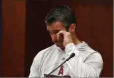  ?? TONY GUTIERREZ — THE ASSOCIATED PRESS ?? Angels manager Brad Ausmus wipes tears from his eyes as he responds to questions during a news conference before Tuesday night’s game against the Rangers in Arlington, Texas.