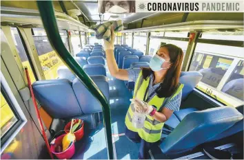  ?? Ahmed Ramzan/Gulf News ?? Buses of School Transport Services (STS) undergoing sanitisati­on as per all safety protocols ahead of the start of the new academic year today in the UAE.