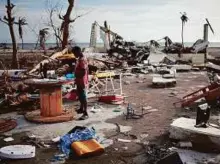  ?? Reuters ?? A boy plays in a building destroyed by Hurricane Matthew in Coteaux, Haiti, on Saturday.