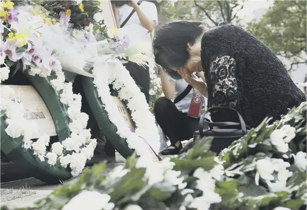  ??  ?? 0 Taeko Yamauchi prays for her elder sister. who died in the 1945 atomic bombing, at an alter to mark ground zero as Nagasaki marks the 74th anniversar­y of the blast