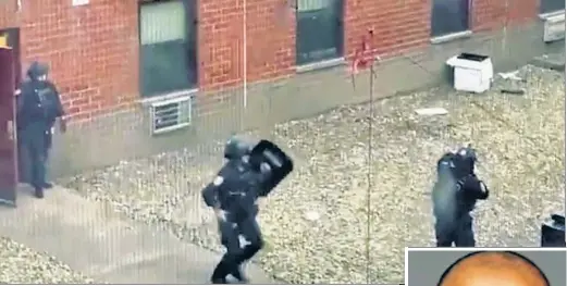  ?? ?? BARRICADED: NYPD officers in bulletproo­f vests and toting shields (above) serve a warrant on Kent Edwards (right) Thursday at 206 Eldridge St. — fatally shooting him after he allegedly fired at them, striking a vest and two shields (below).