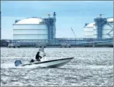  ?? BLOOMBERG VIA GETTY IMAGES ?? A powerboat passes storage tanks at the Cheniere Energy Inc liquefied natural gas terminal in Sabine Pass, Louisiana.