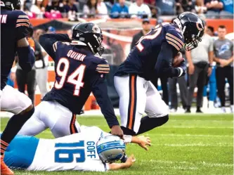  ?? ASHLEE REZIN/SUN-TIMES ?? Bears linebacker Khalil Mack picks up a fumble by Lions quarterbac­k Jared Goff.