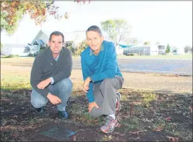  ??  ?? Puketaha School principal Geoff Booth and centenary organiser Bryan Mayall at the plaque where one of the time capsules was believed to be hidden.