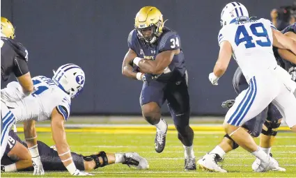  ?? PAULW. GILLESPIE/CAPITAL GAZETTE ?? Navy’s Jamale Carothers, seen running the ball against BYU in the season opener, has not been able to find a rhythm yet this season.