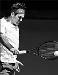  ?? GRAHAM DENHOLM/GETTY ?? Roger Federer plays a backhand shot during his five-set victory Tuesday.