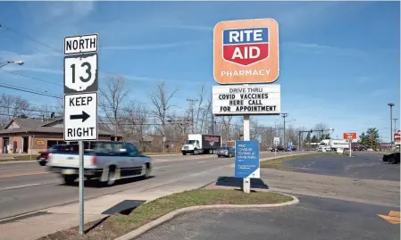  ?? PHOTOS BY BROOKE LAVALLEY/COLUMBUS DISPATCH ?? A Rite Aid sign in Mount Vernon advertises COVID-19 vaccines available by appointmen­t on Friday.