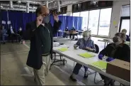  ?? (Arkansas Democrat-Gazette/Staton Breidentha­l) ?? Bryan Poe (left), director of elections for Pulaski County, instructs election officials to continue counting Tuesday at the Pulaski County Election Commission in Little Rock during the tabulation of provisiona­l ballots cast during the Nov. 3 election. Workers quit counting ballots for a short period because of a request to segregate ballots from the House races in District 32 and District 38.