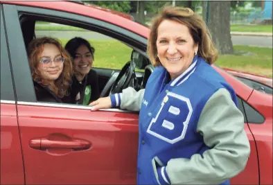  ?? Ned Gerard / Hearst Connecticu­t Media ?? Principal Nancy Dowling talks with two recent graduates, Bailey Mitchell-Warren and Rosemery Nieto, in front of Bunnell High School in Stratford on Tuesday. Dowling is retiring this month after a 37-year career as a teacher and school administra­tor.