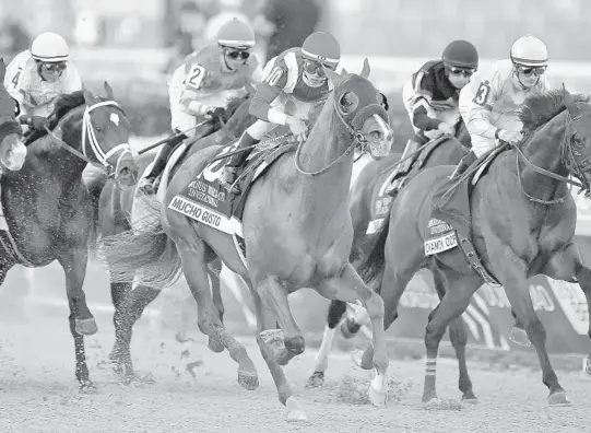  ?? MICHAEL LAUGHLIN/SUN SENTINEL ?? Mucho Gusto, center, ridden by Iran Ortiz Jr., wins The Pegasus World Cup Invitation­al race on Saturday at Gulfstream Park.