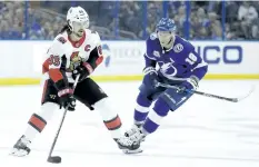  ?? THE ASSOCIATED PRESS FILES ?? Ottawa's Erik Karlsson, left, carries the puck past Tampa Bay's Ondrej Palat earlier this season. The Lightning are believed to be seriously pursuing a trade for Karlsson.