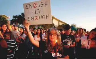  ?? AFP ?? Mourners during a candleligh­t vigil for the victims of school shooting in Parkland, Florida.