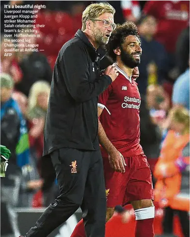  ??  ?? It’s a beautiful night: Liverpool manager Juergen Klopp and striker Mohamed Salah celebratin­g their team’s 4-2 victory over Hoffenheim in the second leg Champions League qualifier at Anfield. — AFP