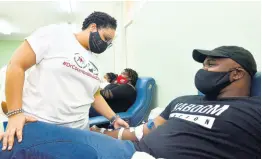  ?? FILE ?? Dr Danielle Levy (left), medical officer at the National Blood Transfusio­n Service, checks on blood donor Jabari Wallace during a blood drive organised by Dr Phillip Coombs last month.