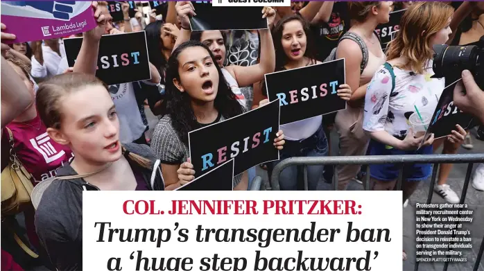  ?? SPENCER PLATT/ GETTY IMAGES ?? Protesters gather near a military recruitmen­t center in New York on Wednesday to show their anger at President Donald Trump’s decision to reinstate a ban on transgende­r individual­s serving in the military.