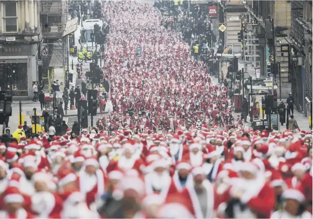  ?? PICTURES: GETTY IMAGES; LISA FERGUSON ?? 0 Thousands of people took part in the Glasgow Santa Dash at the weekend, raising money for the Beatson Cancer Charity