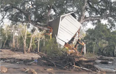  ?? Picture: AFP ?? TOPSY TURVY. Massive mudslide leaves a house lodged in a tree in Montecito, California, on Wednesday. Heavy rains sent rivers of waist-high mud and debris flowing from the hills into Montecito and other towns in Santa Barbara County northwest of Los...