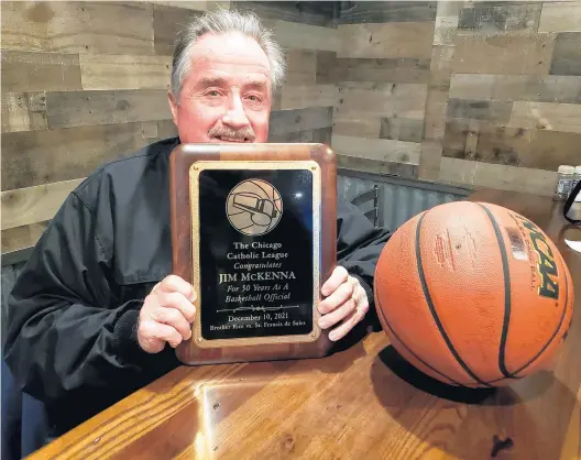  ?? TONY BARANEK/DAILY SOUTHTOWN ?? Jim McKenna shows the plaque he received for 50 years of officiatin­g.