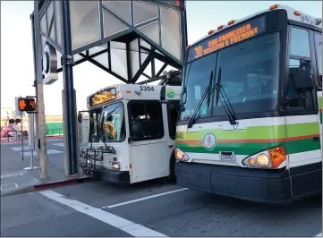  ?? PHOTOS BY SHERRY LAVARS — MARIN INDEPENDEN­T JOURNAL ?? A Golden Gate Transit bus and a Marin Transit bus depart the San Rafael Transit Center on Friday. The latest federal pandemic relief bill is expected to bring about $1.7billion for Bay Area transit services.
