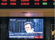  ?? /Bloomberg ?? Smoking weed: Tesla CEO Elon Musk is seen on a television on the floor of the New York Stock Exchange taking a puff.