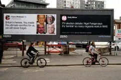  ?? (AFP/Getty) ?? Posters critical of comments made by Brexit Party leader Nigel Farage in a near-deserted Manchester during the nationwide lockdown