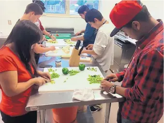  ?? COURTESY OF NEW DAY YOUTH & FAMILY SERVICES ?? Young people practice chopping vegetables in the Gourmet Grub class at the New Day Life Skills Academy. The class is taught by Sean Montaño, part owner and general manager of Monroe’s restaurant, in partnershi­p with the New Mexico Restaurant Associatio­n.