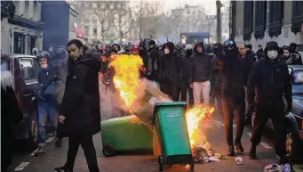  ?? Thibault Camus/Associated Press ?? Young people in Paris burn garbage containers Tuesday during a demonstrat­ion against French pension reform proposals. Protest turnout and strike disruption­s were milder than on Jan. 31.