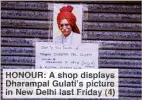  ??  ?? HONOUR: A shop displays Dharampal Gulati’s picture in New Delhi last Friday (4)