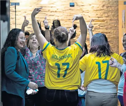  ??  ?? Wearing the shirt: Brazilians have adopted the iconic yellow of the national football team to show their support forJair Bolsonaro (below)