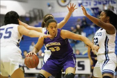  ?? Nikolas Samuels/The Signal (See additional photos on signalscv.com) ?? Valencia’s Skylar Ingram (33) works her way toward the basket as she is surrounded by Saugus defenders during a game at Saugus on Friday. The Vikings won the game 52-28.