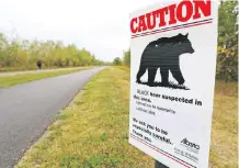  ?? GAVIN YOUNG ?? Signs have been put up warning of a black bear in the area along Glenmore Reservoir near Glenmore Landing.