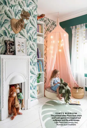  ??  ?? ESME’S BEDROOM The painted white floors look smart and fresh against the tropical leaf wallpaper and the pink canopy. Light Peach bed canopy, £94, Numero 74 at Smallable