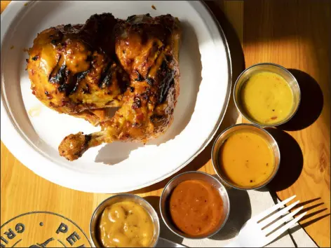  ?? CAITLIN OCHS — THE NEW YORK TIMES ?? Peri Peri half chicken with house-made hot sauces at Piri Piri Grill House in Brooklyn on June 8, 2019. Deeper and more complex use of heat will show up in restaurant dishes and at the grocery store.