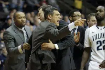  ?? AP FILE ?? Villanova assistant coach Kyle Neptune, left, behind a fired up head coach Jay Wright during a game in 2014, is a major part of the staff that works behind the scenes on weeks like this — ahead of the NCAA Tournament — to devise detailed scouting...