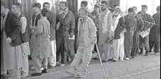  ?? AP ?? Afghan men line up to cast their votes, inside a polling station during the Parliament­ary election in Kabul on Saturday.