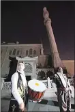  ??  ?? On the first day of the Muslim Holy Month of Ramadan, a drummer, wearing traditiona­l Ottoman clothes, performs on the streets of a neighborho­od in Istanbul.