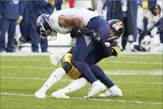  ?? GENE J. PUSKAR — THE ASSOCIATED PRESS ?? Pittsburgh Steelers cornerback Joe Haden (23) stops Tennessee Titans wide receiver Nick Westbrook-Ikhine (15) after Westbrook-Ikhine made a catch on fourth down near the end of the second half.