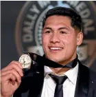  ??  ?? Roger Tuivasa-Sheck shows off his Dally M award medal.