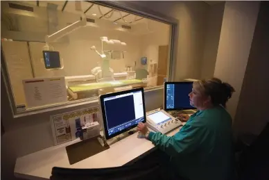  ?? Staff photo by Evan Lewis ?? Sandra Barrett, radiology technologi­st, sets up for a fluoroscop­y exam Friday at Wadley Regional Medical Center.