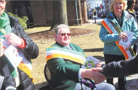  ?? Ned Gerard / Hearst Connecticu­t Media ?? Above, Peter Carroll, grand marshal for the 2019 Greater Bridgeport St. Patrick’s Day Parade, greets supporters in Bridgeport on Monday. The parade and other festivitie­s will take place in downtown Bridgeport on Friday. At left, a sign promotes Friday’s Greater Bridgeport St. Patrick’s Day Parade.