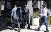  ?? BENJAMIN FANJOY / AP ?? Igor Fayermark, right, from the FDIC enters Silicon Valley Bank’s headquarte­rs in Santa Clara on Monday.