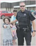  ??  ?? Const. Shawn Mohle of the Moose Jaw Police Service ‘arrests’ Colton Cushing during South of the Bridge Days.